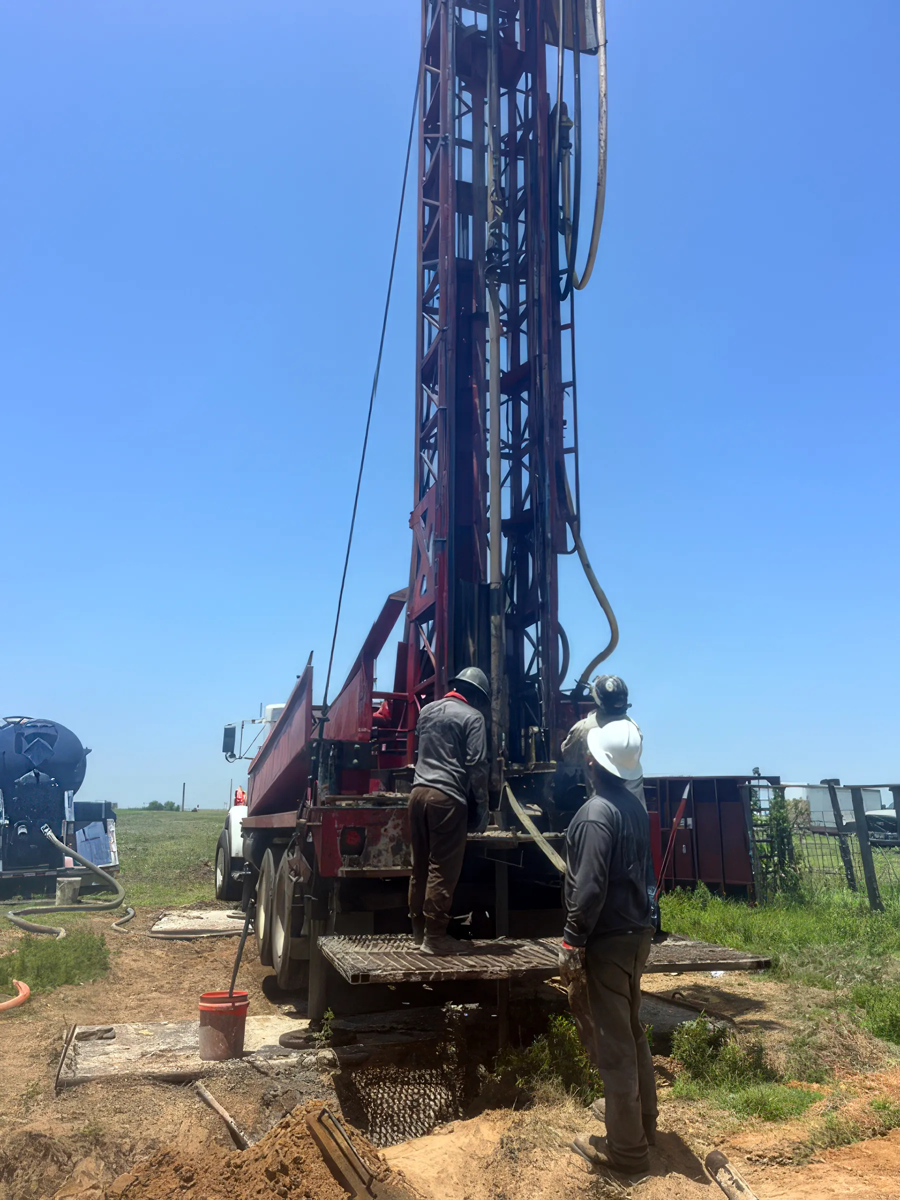 DFW Well Service crew running a water well drilling rig near Anna, TX